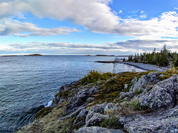 a view of the rocky Rock Harbor shoreline from the edge of the Stoll Memorial Trail