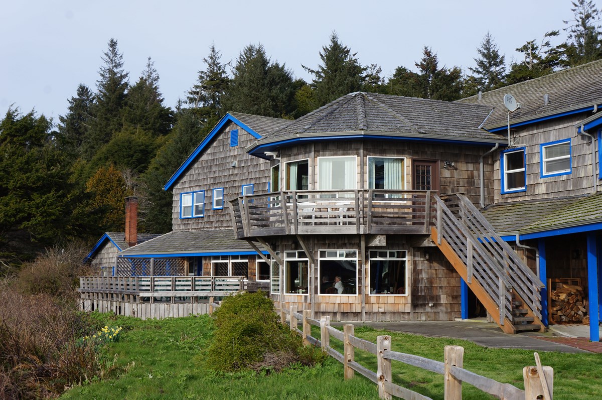 A lodge building with wooden shingles on a bluff.