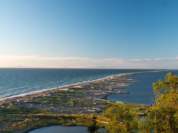 A long rocky spit extends into a large body of water.