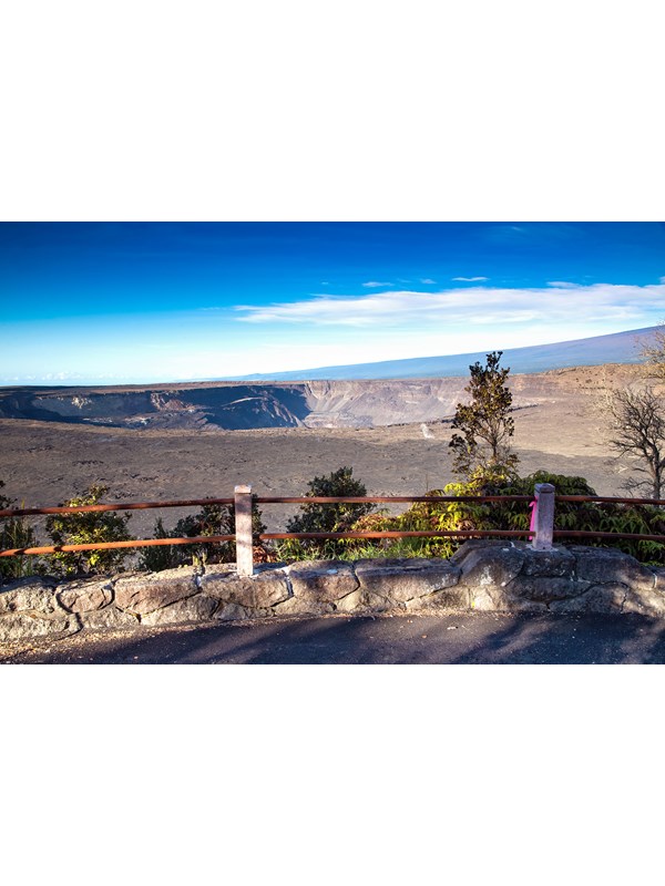 Overlook into a volcanic crater with trees in the foreground