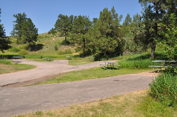 a picnic area with tables and several parking spots