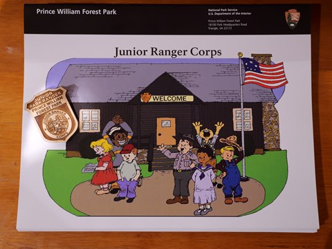 Junior Ranger Booklet with images of children in front of a cabin with at wooden badge laying on top