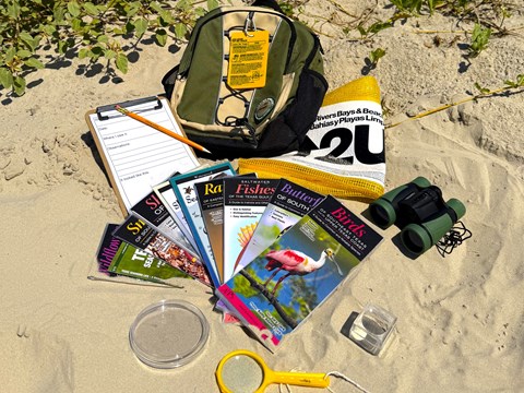 A backpack with a variety of educational tools.