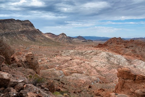 A cloudy sky over a mountainous landscape.