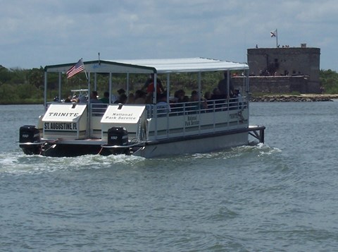 Ferry boat in the water with the Fort in the background