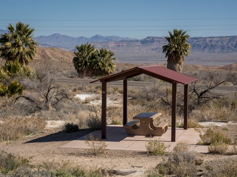 A picnic shelter with a desert landscape