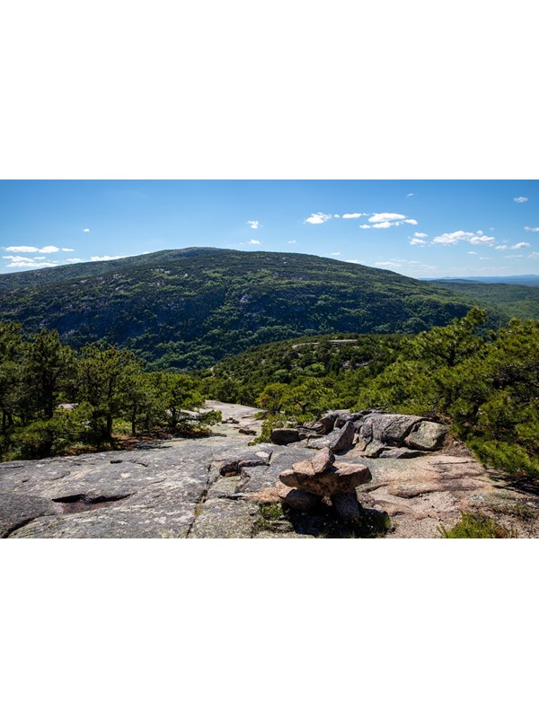 Rock cairns mark a trail on exposed rock