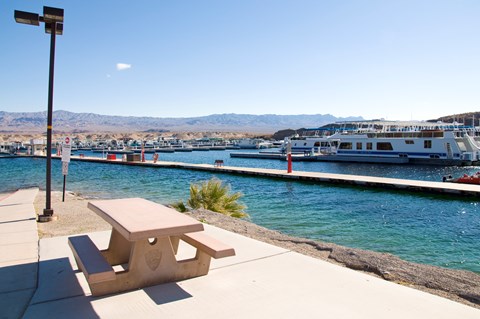 A picnic table next to a body of water