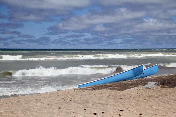 Photo of canoes sitting on Portage Lakefront and Riverwalk shoretline.