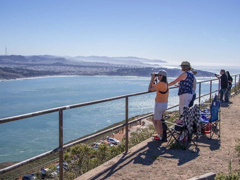 Visitors looking for birds from the Hawk Hill Overlook.