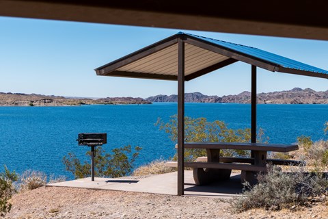 a picnic shelter next to a body of water