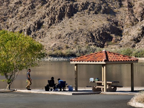 a picnic shelter next to water