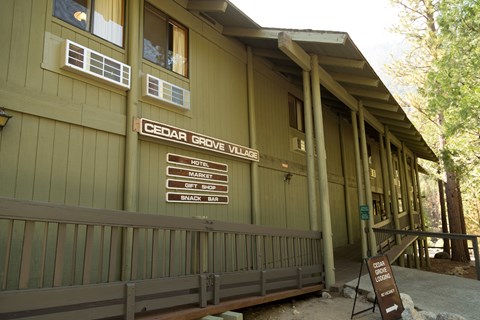 Large green wooden building housing the Cedar Grove lodge and market