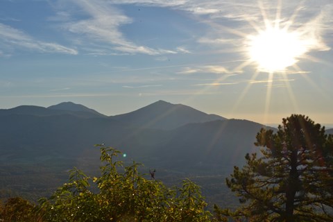 The sun rising over a mountains on a clear morning