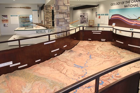Relief map depicting desert landscape with a man-made lake. Metal railings
