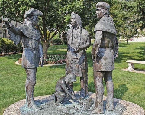 large statue with several men