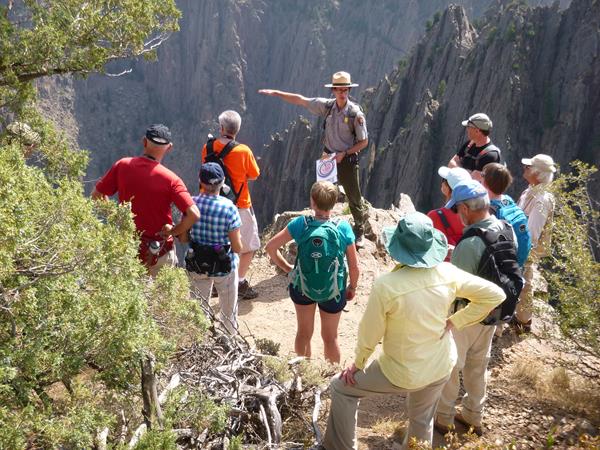 A ranger leads a group of visitors on a geology walk.