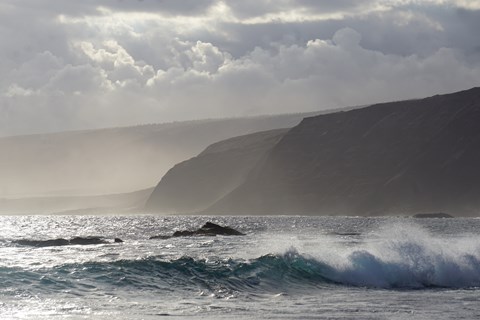 Ocean waves and coastal cliffs shortly before sunset