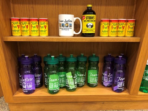 gift shop souvenirs: water bottles, "slap ya mama" seasoning, coffee mug