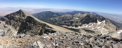 View from wheeler peak with blue skies and rocky mountain peaks.