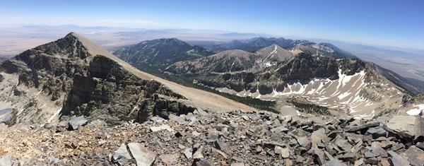 View from wheeler peak with blue skies and rocky mountain peaks.
