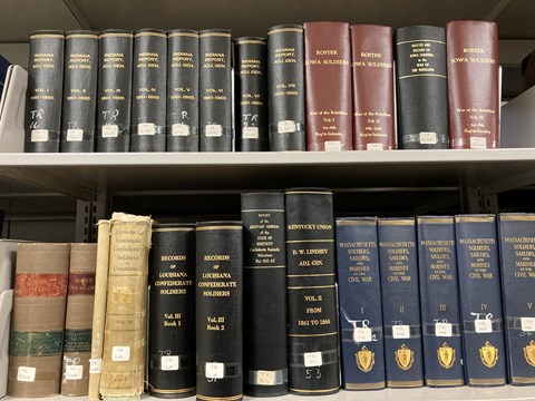Two shelves of thick research books