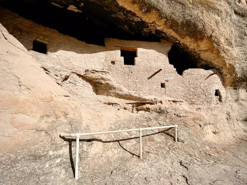 Stone stacked walls with "T" shaped door in an alcove.