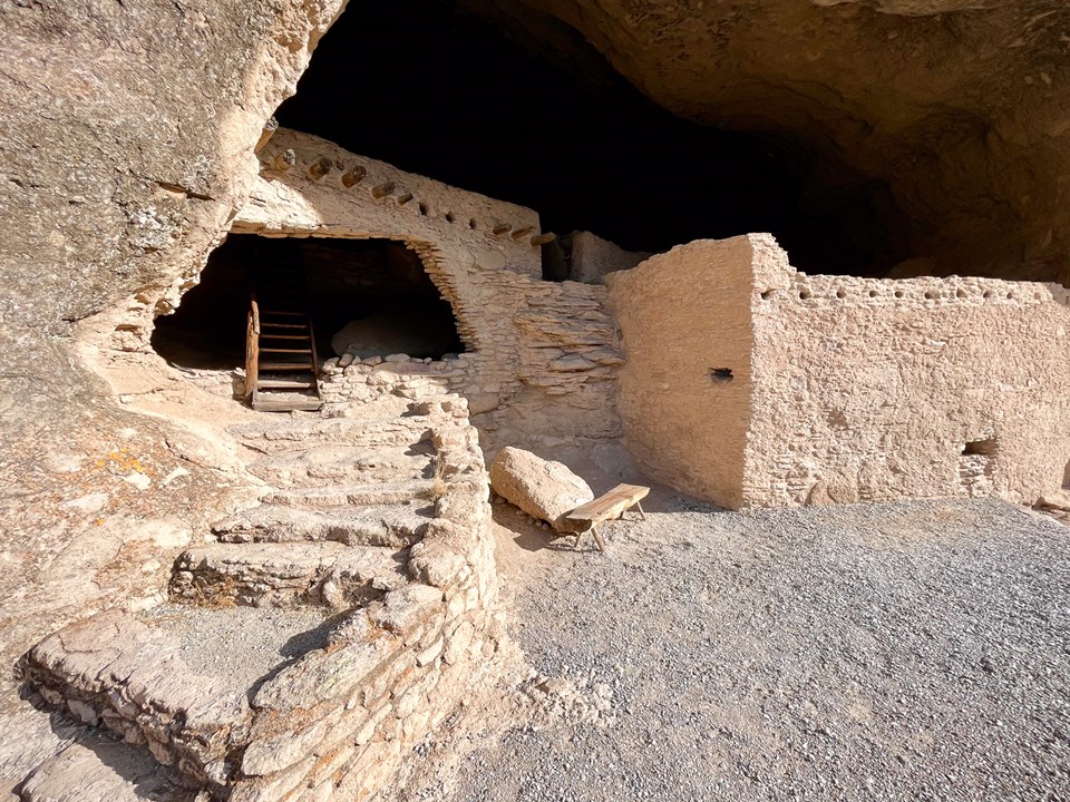 Stone building with a stone staircase leading up to it.
