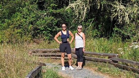 Two hikers along a gravel path