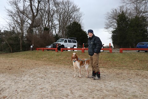 person standing with dog on leash