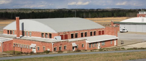 Hangar 1 from overlook. Concrete walking path with exhibit waysides.