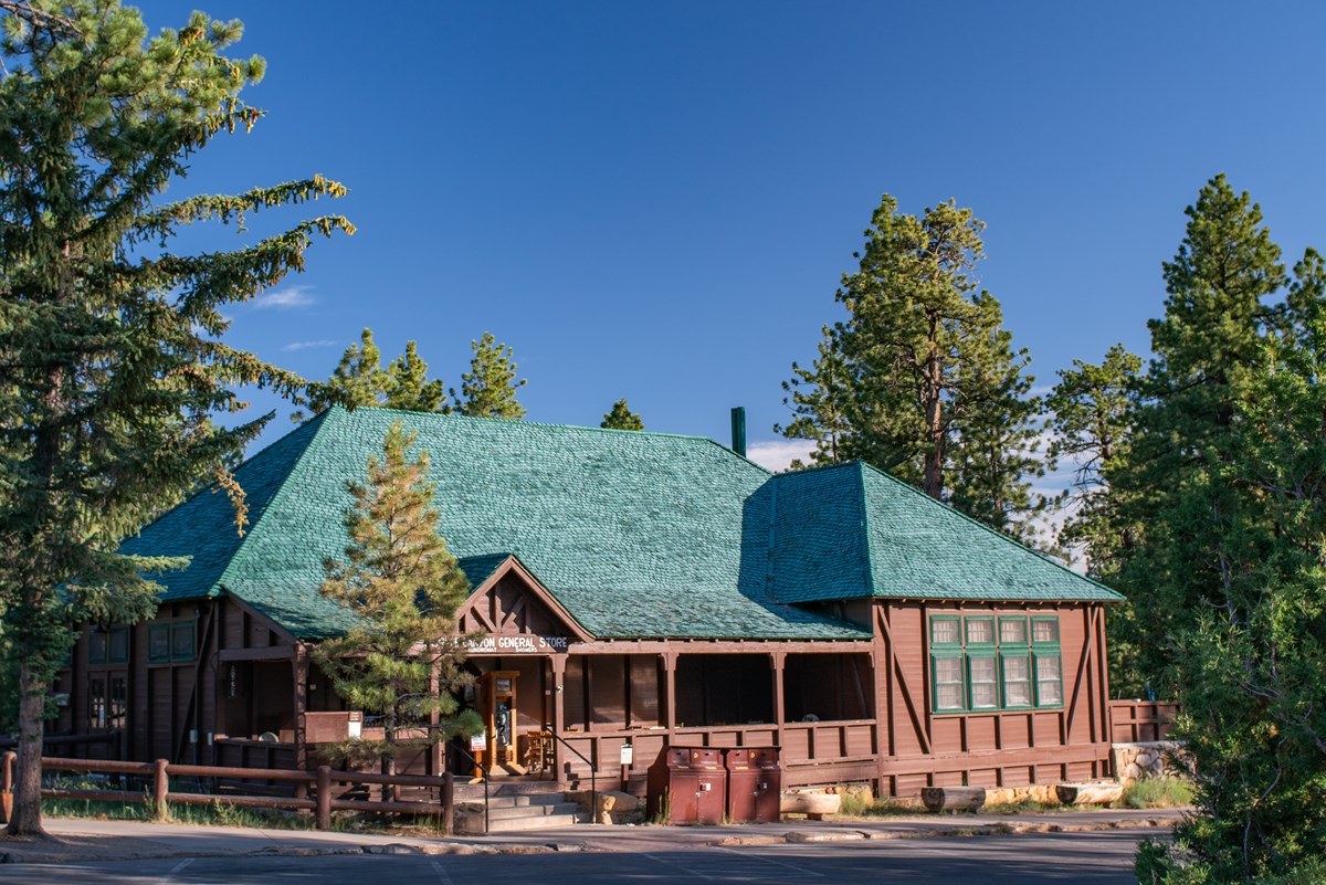 Photo of a large wooden structure with dark green roof.