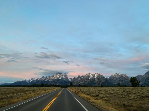 A road leading towards a mountain range.