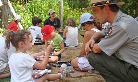 A young girl talking to a Park Ranger.