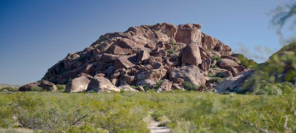 A trail leads to a rock formation