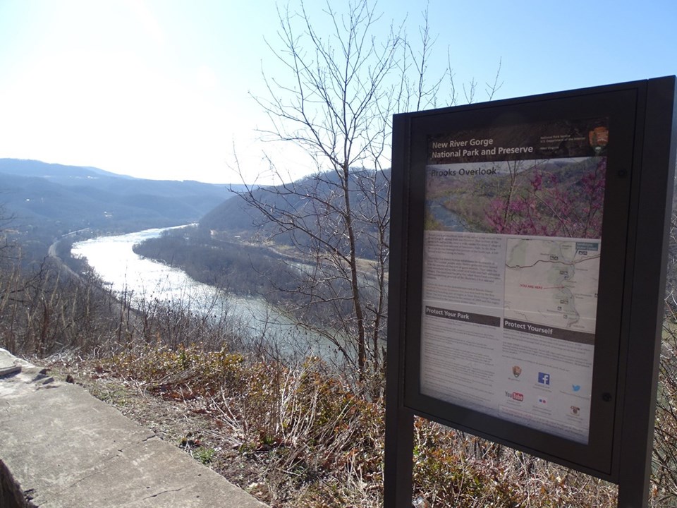 Brooks Island, an island in the river, as seen from the overlook. An info sign is in the foreground.
