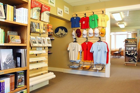 Retail area with books, maps, hats, and shirts lining the walls.