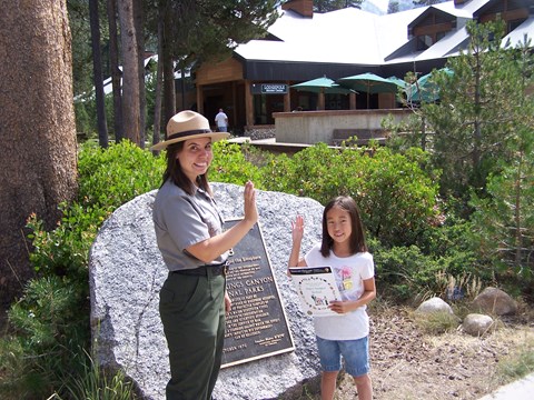 A ranger swears in a child as a Junior Ranger