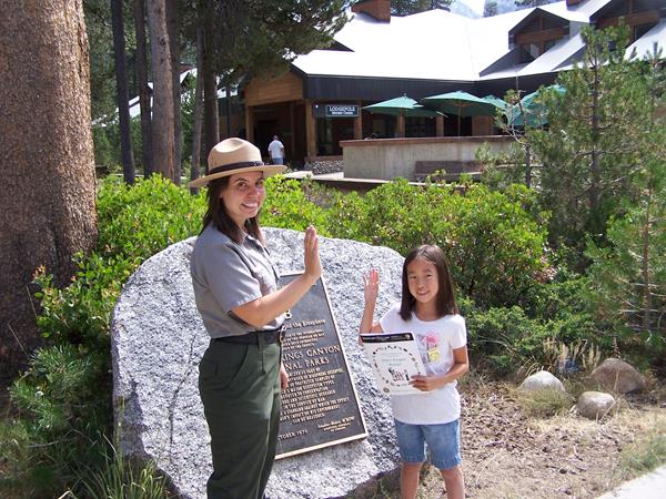 A ranger swears in a child as a Junior Ranger