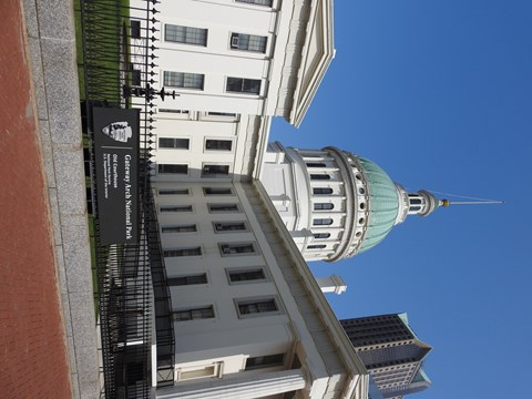 A white Greek Revival-style building with a green dome