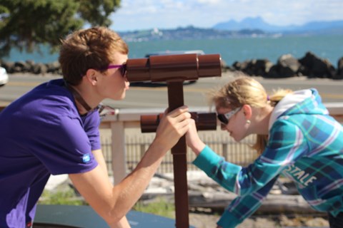 Film camp youth learning about surveying at Middle Village