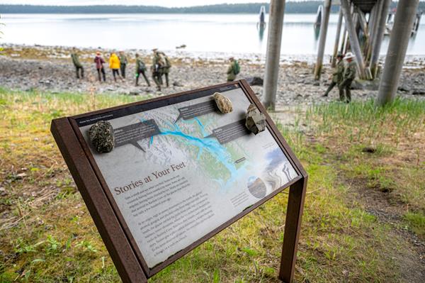 A wayside sign shows info about geology in Bartlett Cove.