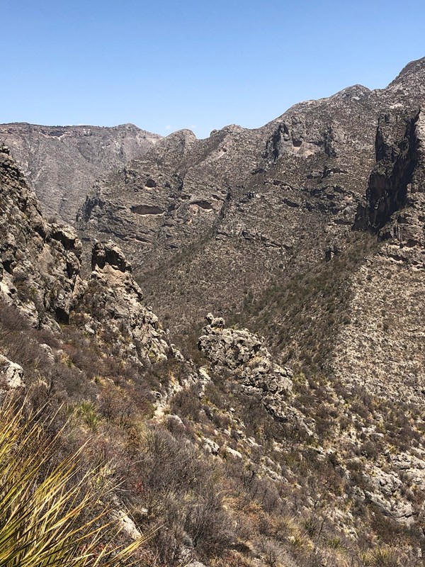 A trail runs through a small gap in a ridge