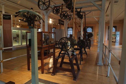 Various machines used to produce firearms in a museum.