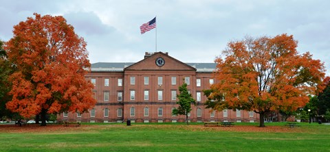 Springfield Armory set behind two colorful trees in fall.