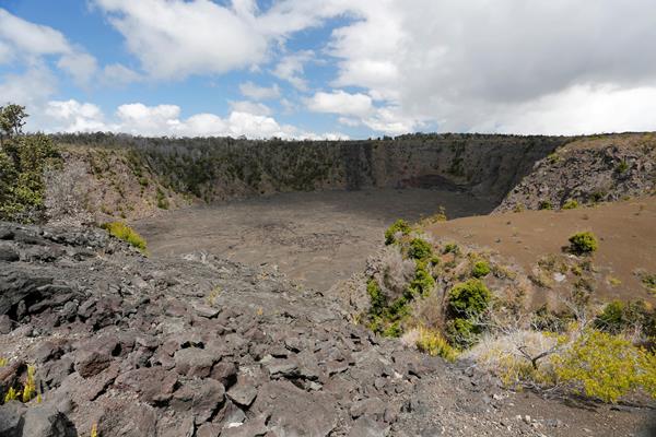 Pit crater with stone wall in the foreground