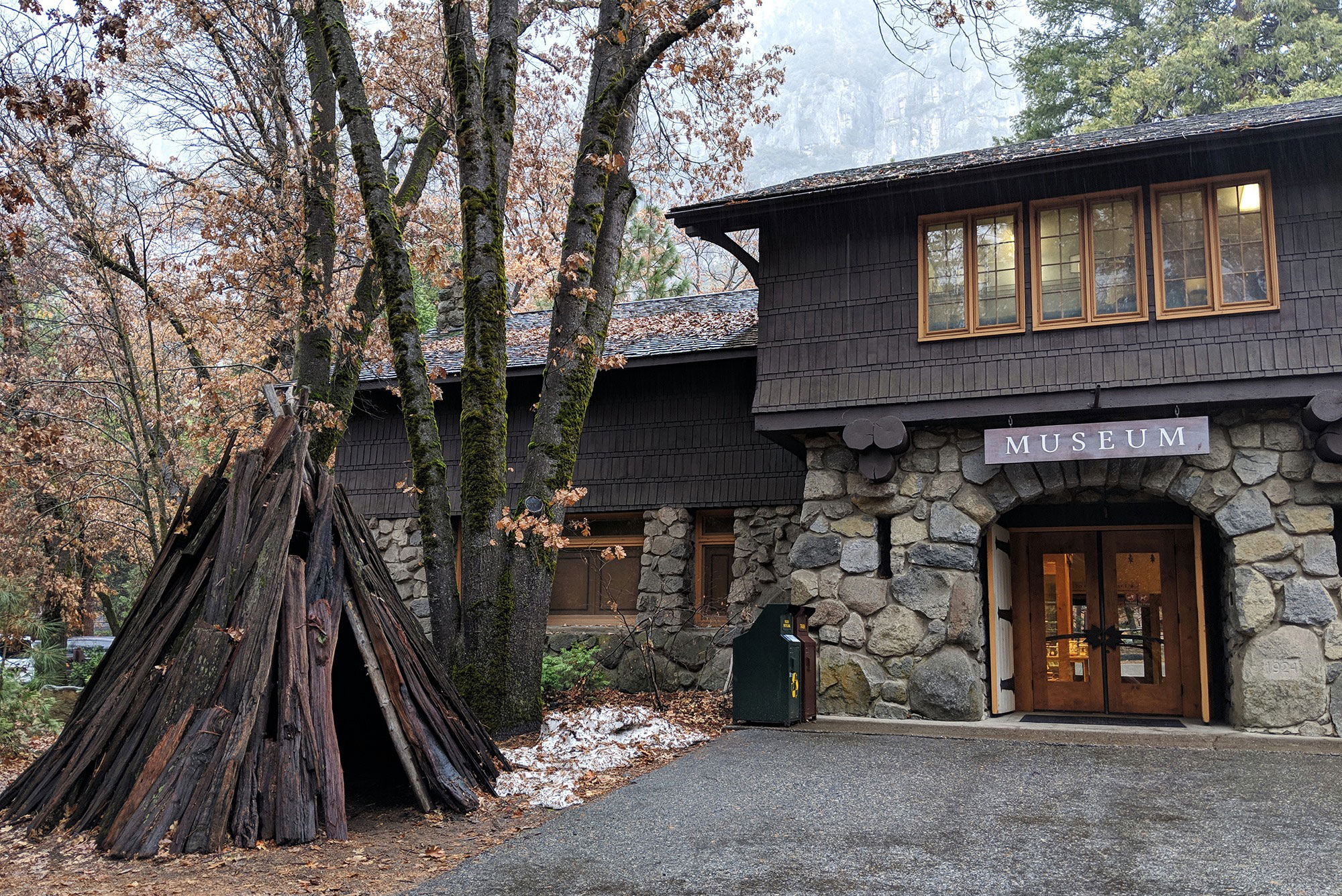 Yosemite Museum building with wood bark house to the left of the main door