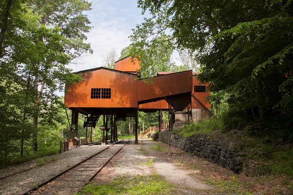 A red coal tipple standing over old railroad tracks
