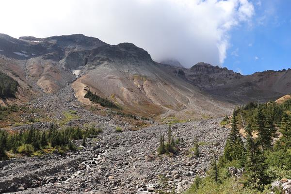 A rocky river bed surrounded by rocky mountain slopes.