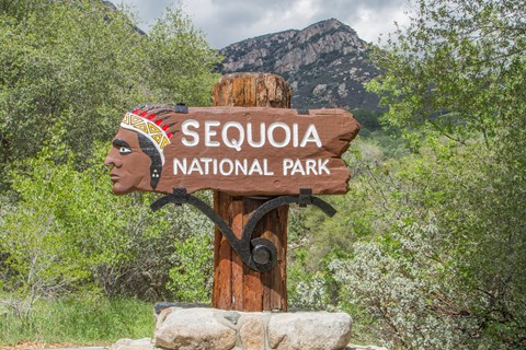 A painted sign of an indigenous person with the words Sequoia National Park.